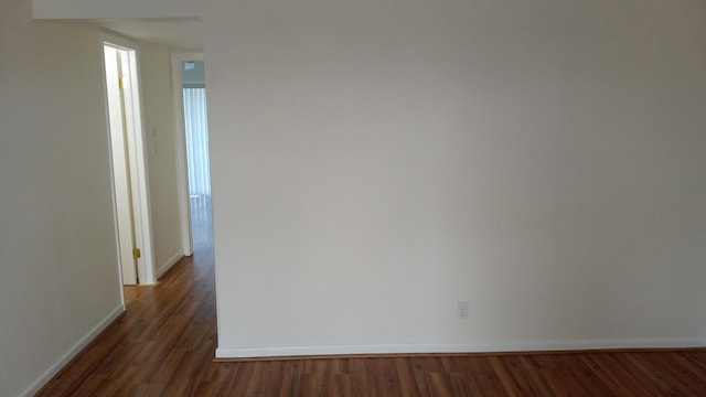 empty room with dark hardwood / wood-style floors