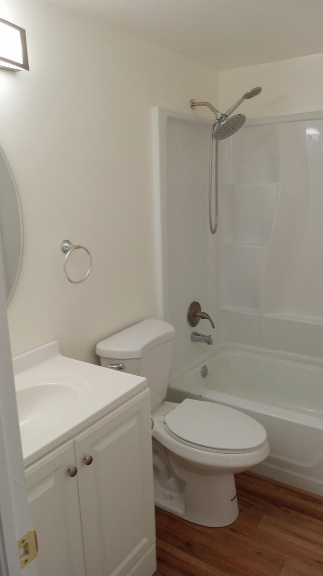 full bathroom featuring vanity, toilet, wood-type flooring, and tub / shower combination