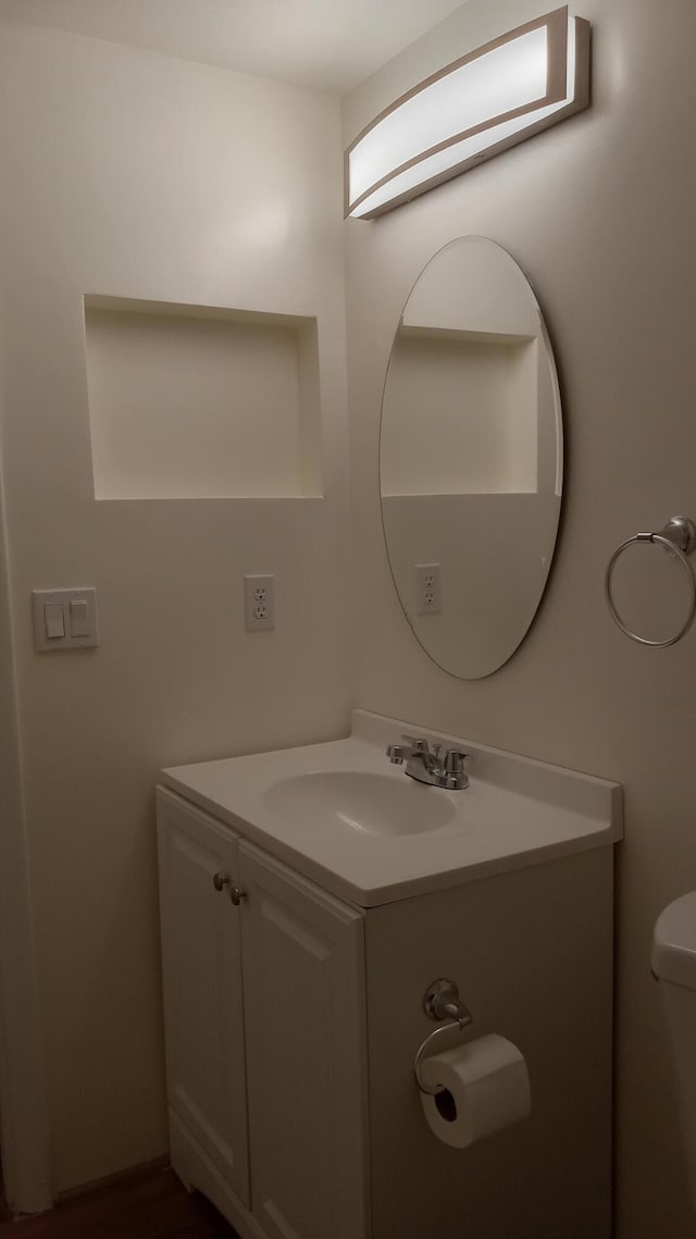 bathroom featuring toilet and vanity