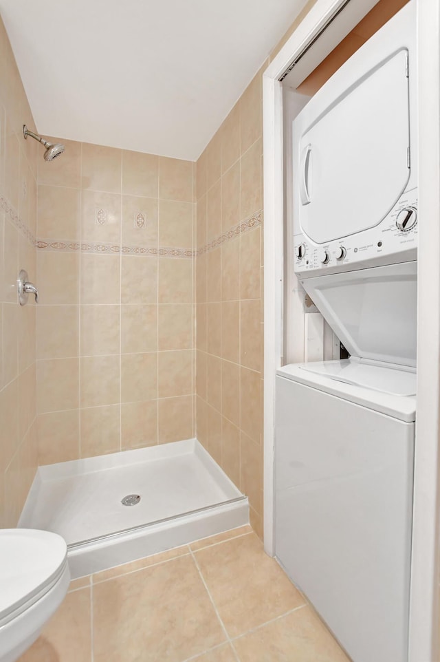 21864 Arriba Real Unit 3D, Boca Raton, FL 33433 - bathroom with tile patterned flooring, stacked washer / dryer, toilet, and a stall shower