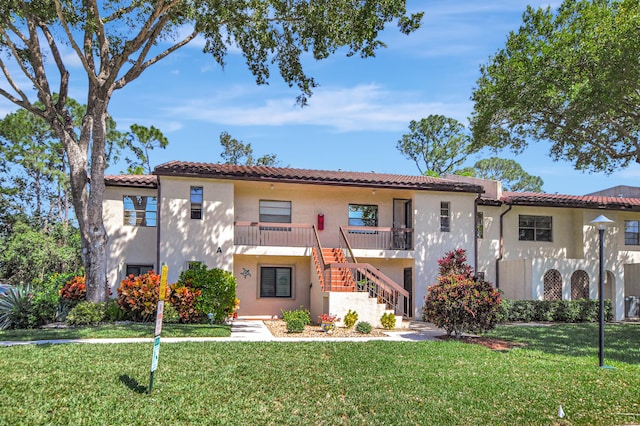 mediterranean / spanish house with a front lawn