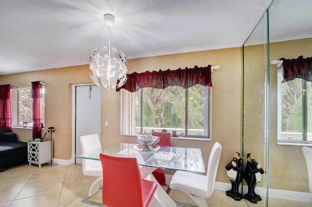 dining space featuring a notable chandelier, light tile patterned flooring, and a healthy amount of sunlight