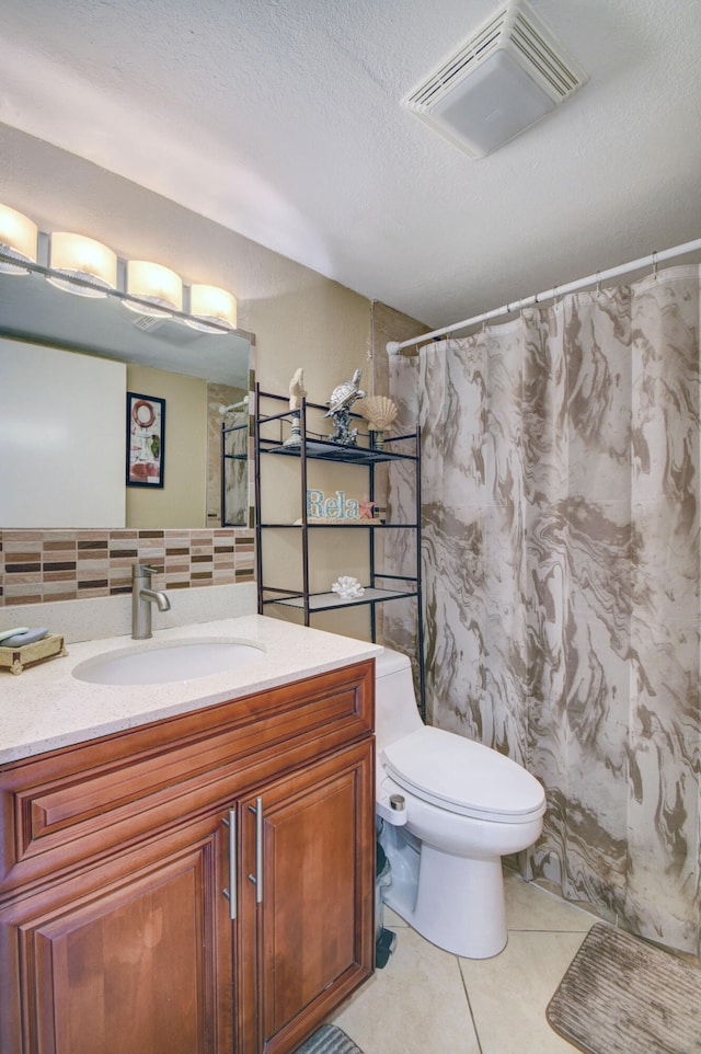 bathroom featuring vanity, toilet, a textured ceiling, backsplash, and tile patterned flooring