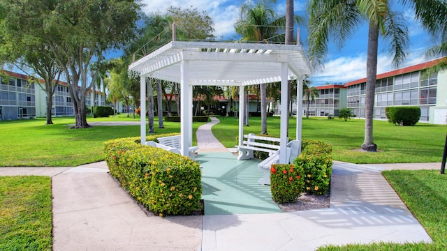 view of home's community featuring a pergola and a yard