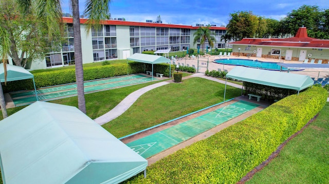 view of home's community with a lawn and a pool