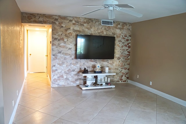 unfurnished living room featuring light tile patterned flooring and ceiling fan