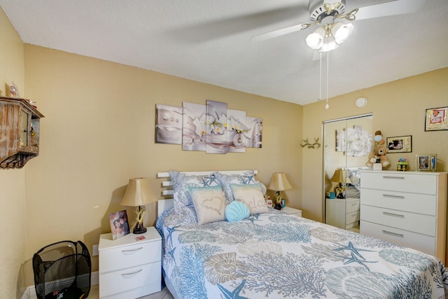 bedroom with ceiling fan and a closet