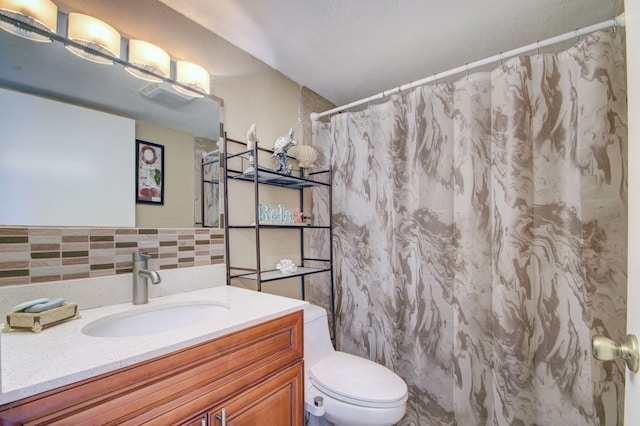 bathroom featuring backsplash, a shower with curtain, vanity, and toilet