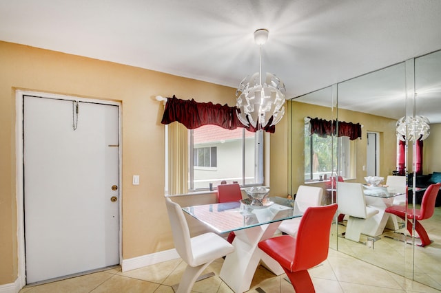 dining area with an inviting chandelier and light tile patterned floors