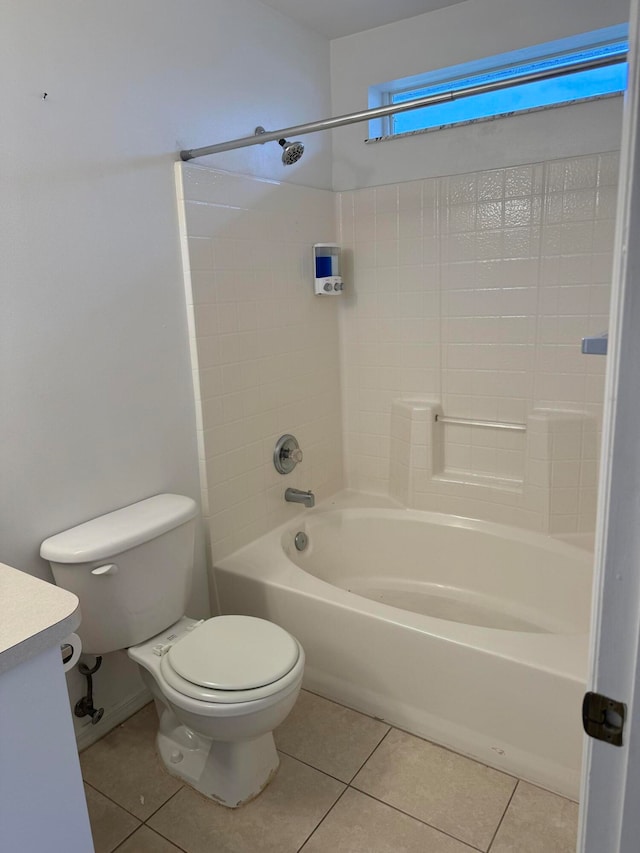 full bathroom featuring toilet, tile floors, vanity, and tub / shower combination