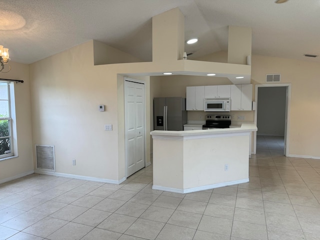 kitchen with light tile floors, white cabinetry, appliances with stainless steel finishes, and a chandelier