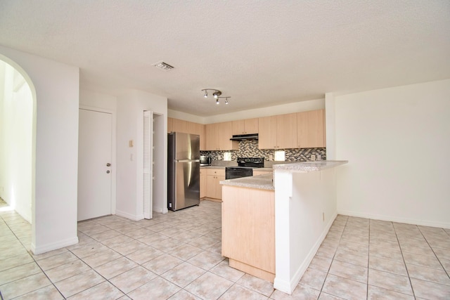 kitchen with backsplash, light brown cabinets, light tile floors, range with electric cooktop, and stainless steel refrigerator