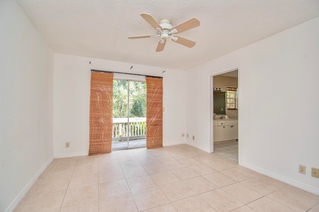 tiled empty room featuring a textured ceiling and ceiling fan