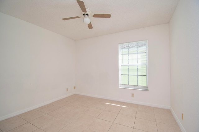 tiled empty room with ceiling fan