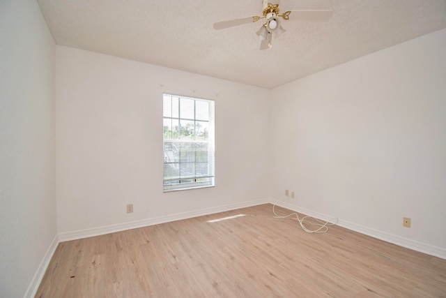 empty room with a textured ceiling, ceiling fan, and light wood-type flooring