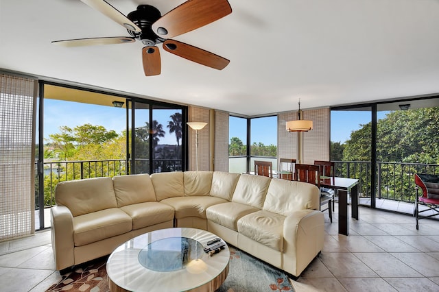 living room featuring floor to ceiling windows, ceiling fan, and light tile patterned floors