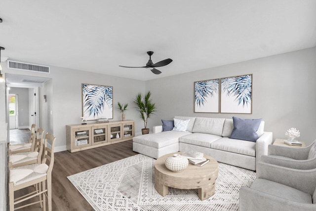 living room featuring ceiling fan and dark hardwood / wood-style flooring