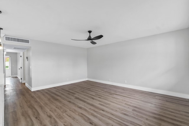 spare room featuring dark hardwood / wood-style flooring and ceiling fan