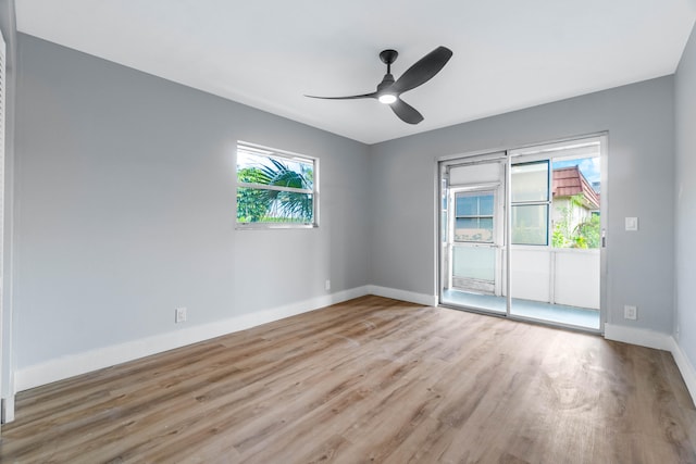 empty room featuring ceiling fan, light wood-type flooring, and a healthy amount of sunlight