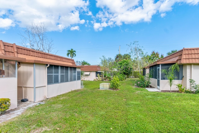 view of yard with a sunroom