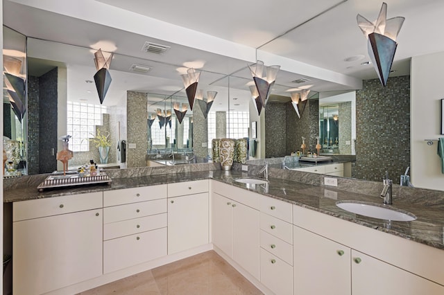 bathroom featuring vanity, tasteful backsplash, and tile patterned flooring