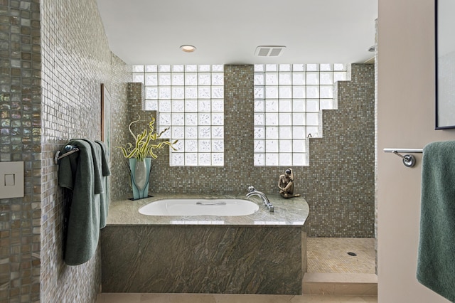 bathroom featuring plus walk in shower and tile patterned floors