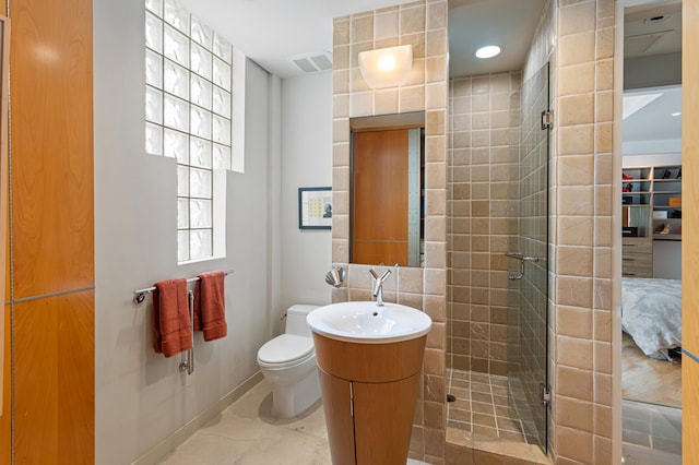 bathroom with vanity, a shower with shower door, and toilet