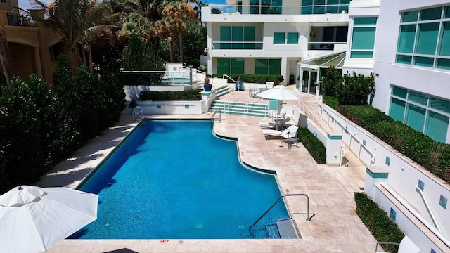 view of swimming pool featuring a patio area