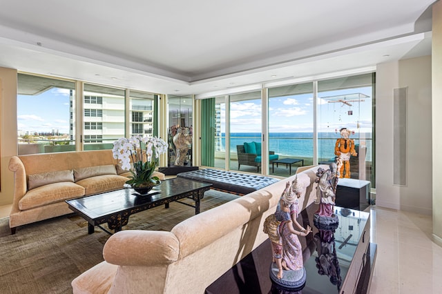 living room featuring a water view and tile patterned flooring