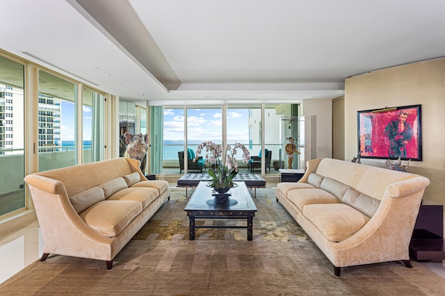 living room with a wall of windows and a water view