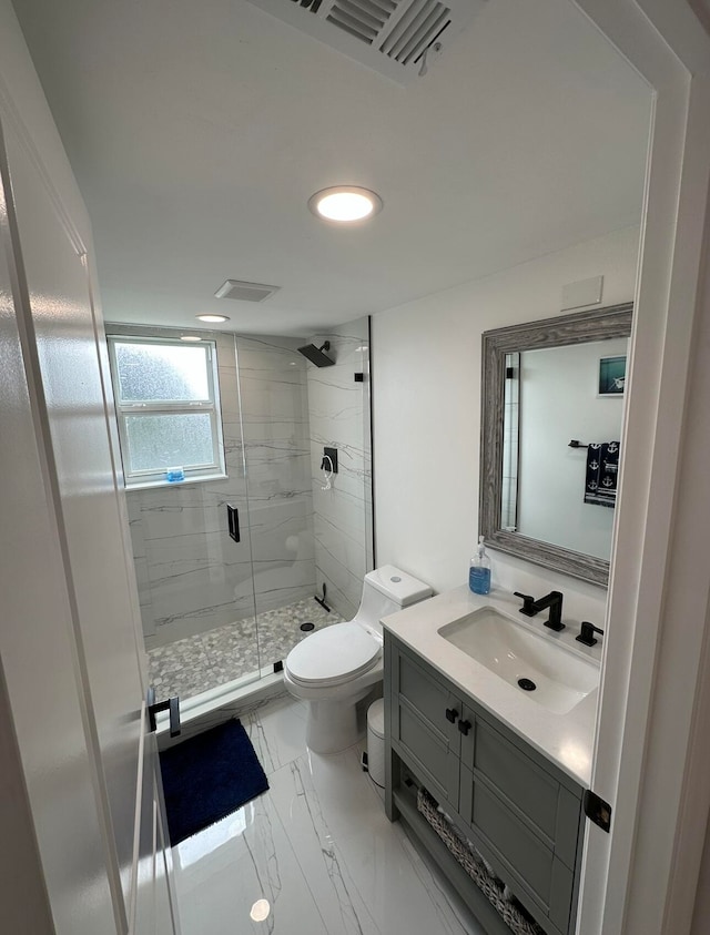 bathroom featuring toilet, a shower with door, large vanity, and tile flooring