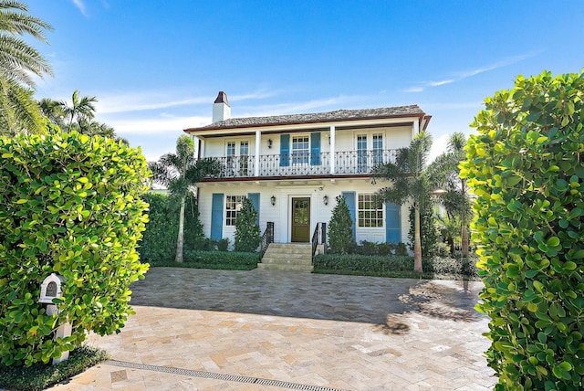 view of front of house featuring a balcony