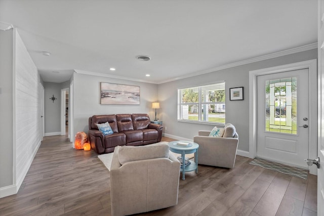 living room featuring wood-type flooring and ornamental molding