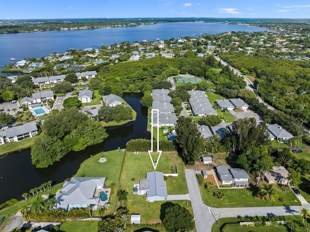 birds eye view of property with a water view