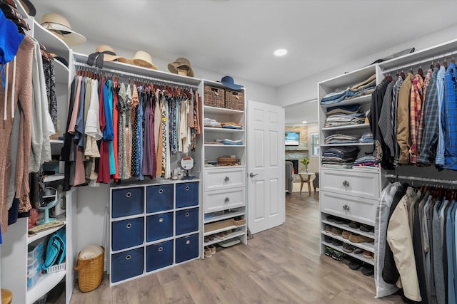 walk in closet with light wood-type flooring