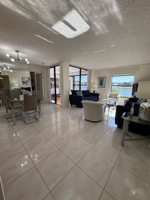 living area with light tile patterned floors and a textured ceiling