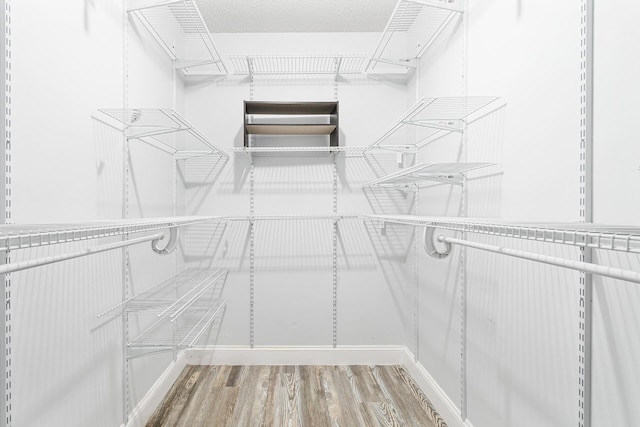 walk in closet featuring hardwood / wood-style floors