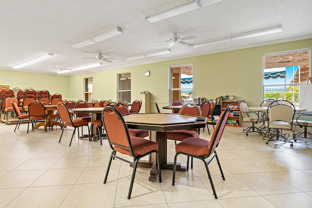 tiled dining space featuring ceiling fan and a textured ceiling