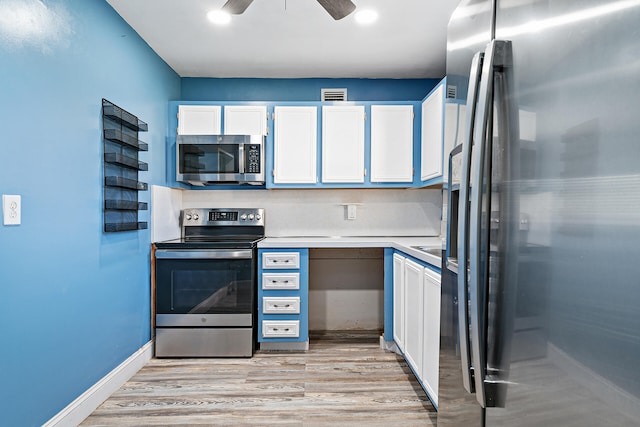 kitchen featuring ceiling fan, stainless steel appliances, light hardwood / wood-style flooring, and white cabinets