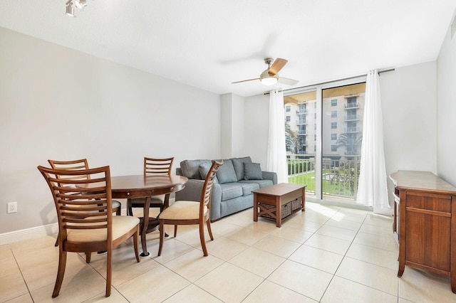 dining area featuring light tile floors and ceiling fan