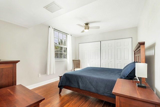 bedroom with ceiling fan, a closet, and dark wood-type flooring