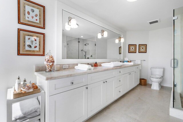 bathroom with walk in shower, tile flooring, large vanity, and toilet