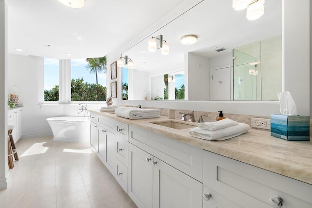 bathroom with tile floors, dual bowl vanity, and independent shower and bath