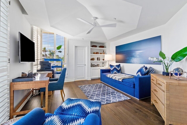 living room with ceiling fan and dark wood-type flooring