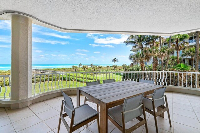 view of terrace featuring a balcony and a water view