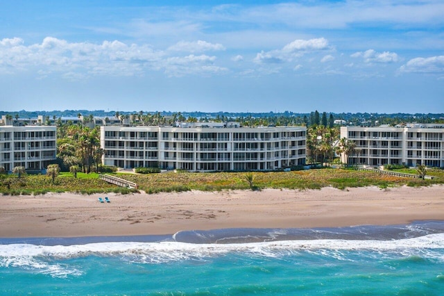 aerial view featuring a view of the beach and a water view