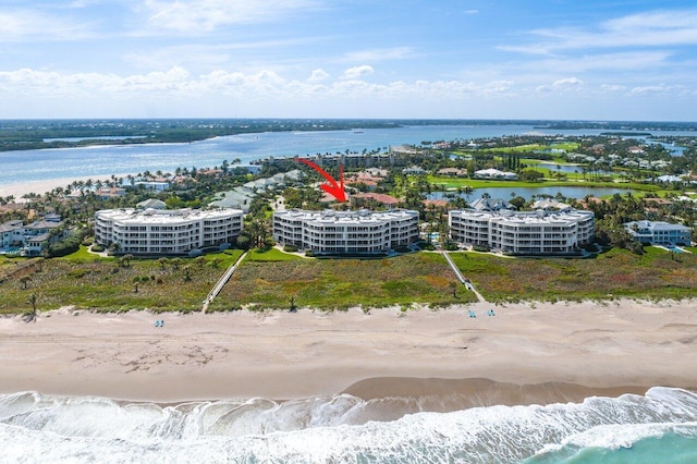 drone / aerial view featuring a water view and a beach view