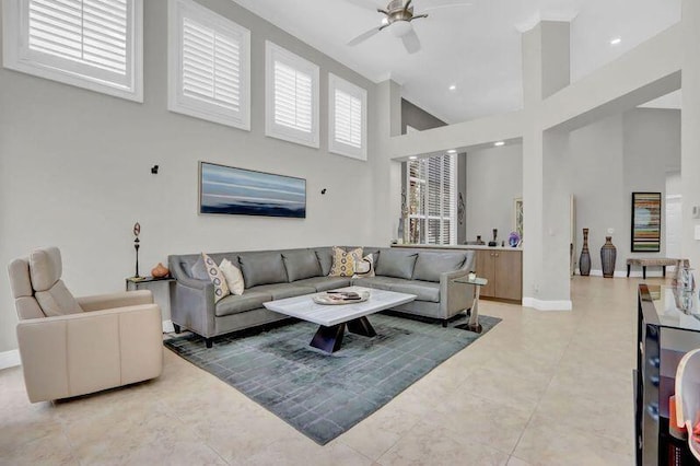 tiled living room featuring a towering ceiling and ceiling fan