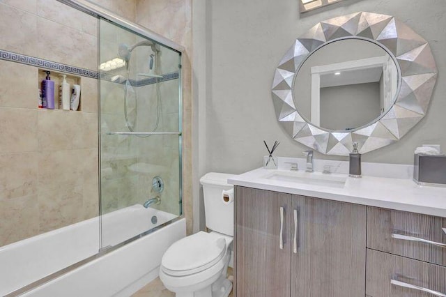 full bathroom with vanity, enclosed tub / shower combo, and toilet