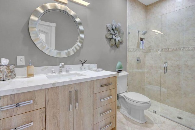 bathroom featuring a shower with door, vanity, toilet, and tile patterned floors